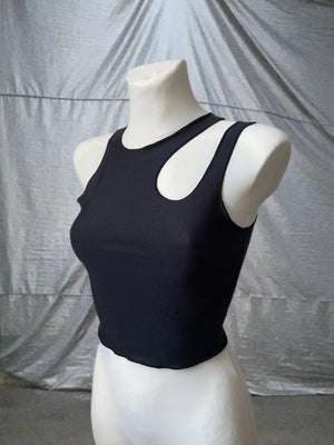 Black cutout top with a cropped fit in an alternative style.