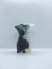 Vegan handmade candle with a marbled pattern of a naked man.