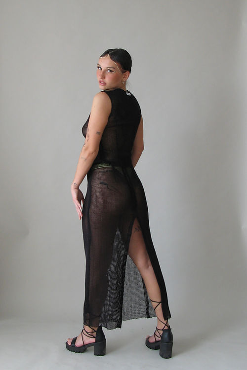 Black net maxi skirt with a large slit in the back.