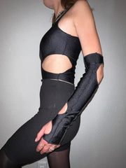 Black cutout top with matching sleeves in an alternative fashion style.