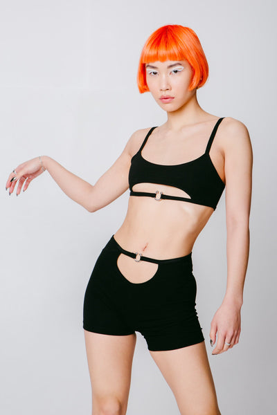 Black crop top with an underboob cutout and a piercing closure.