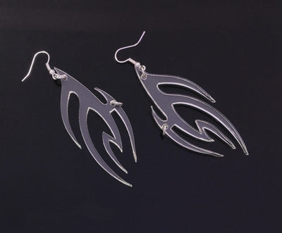 Clear earrings in a tribal or flame pattern with a silver ring piercing from IVY Berlin