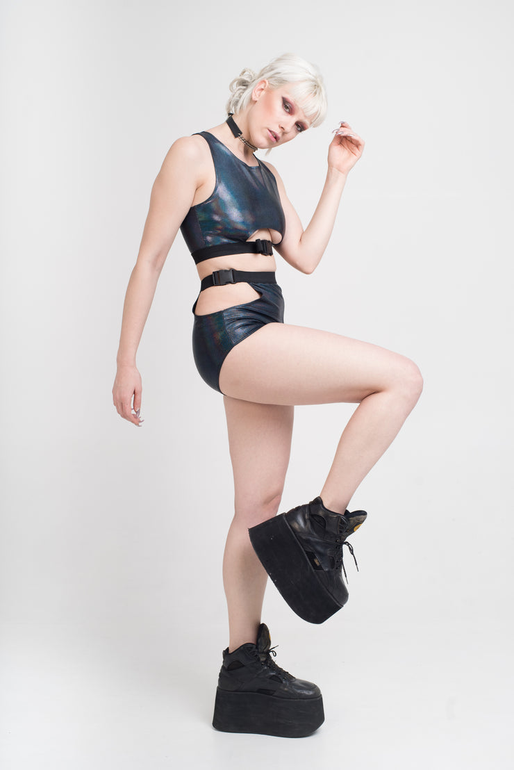 Black holographic shorts with a buckle detail and hip cutouts.
