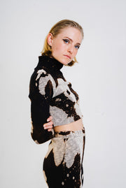 Long sleeved black and white bleached top with a turtleneck.